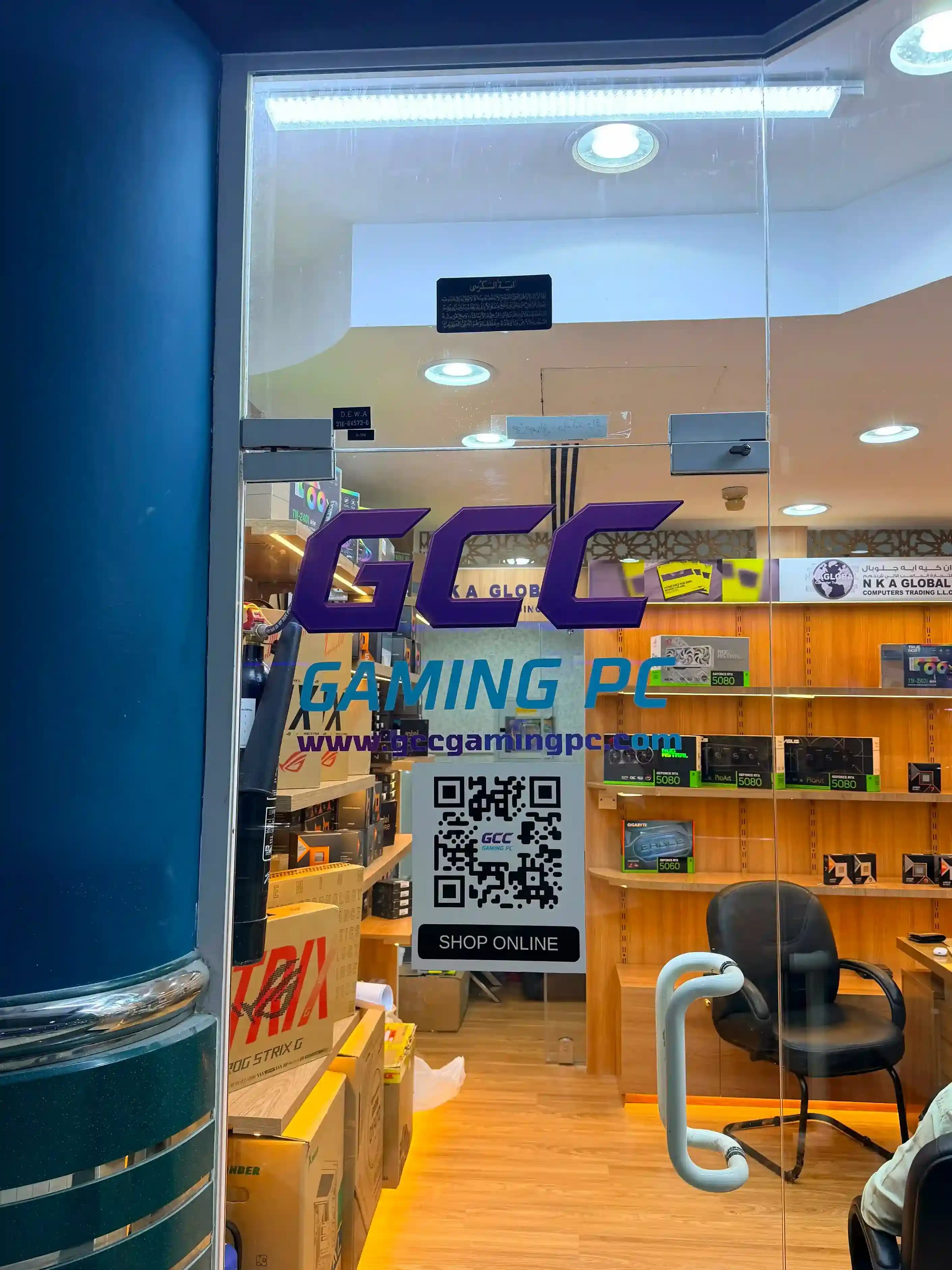 GCC Gaming PC glass entrance door with branding and shop-online QR code at Al Khaleej Center, Bur Dubai